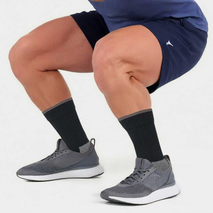 athletic man wearing compression crew socks for running and training